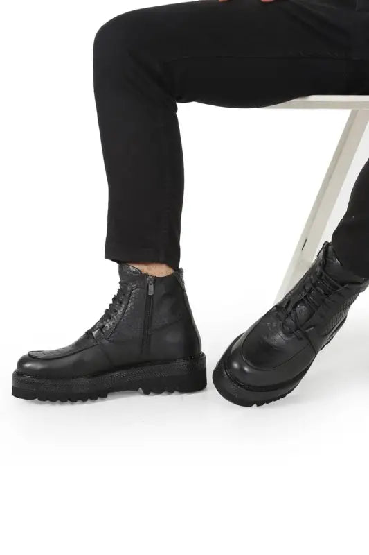 Black leather combat boots with chunky soles and laces.