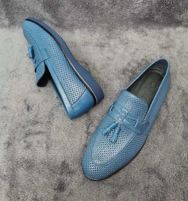 Light blue leather loafers with perforated detailing and tassels.