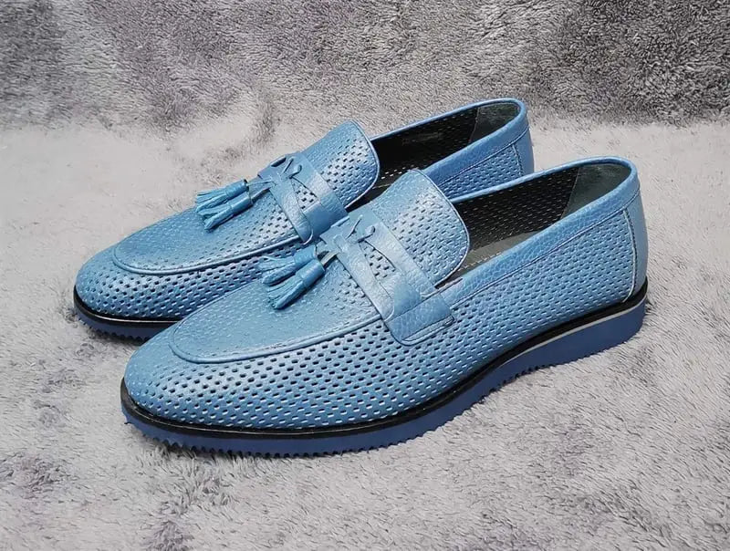 Light blue leather loafers with tassel details and perforated texture.