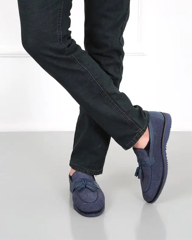 Navy blue slip-on loafers with bow detail and textured soles.