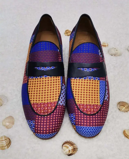 Colorful patterned loafers featuring geometric designs in blue, purple, and orange.