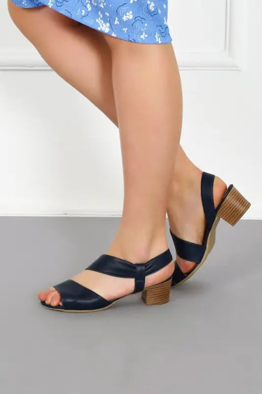 Navy blue leather sandal with a wooden block heel and slingback strap.