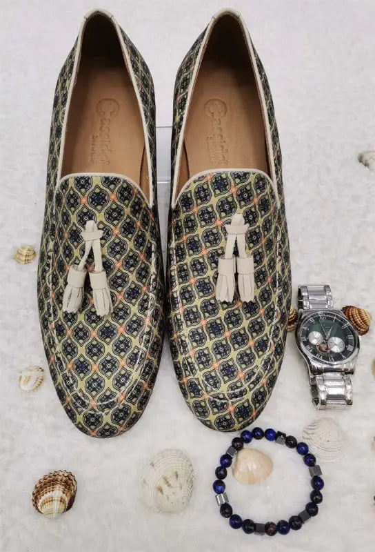 Patterned loafers with white tassels and a geometric print design.