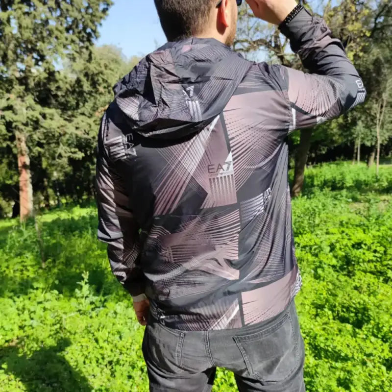 Grey and black patterned athletic jacket with geometric designs.