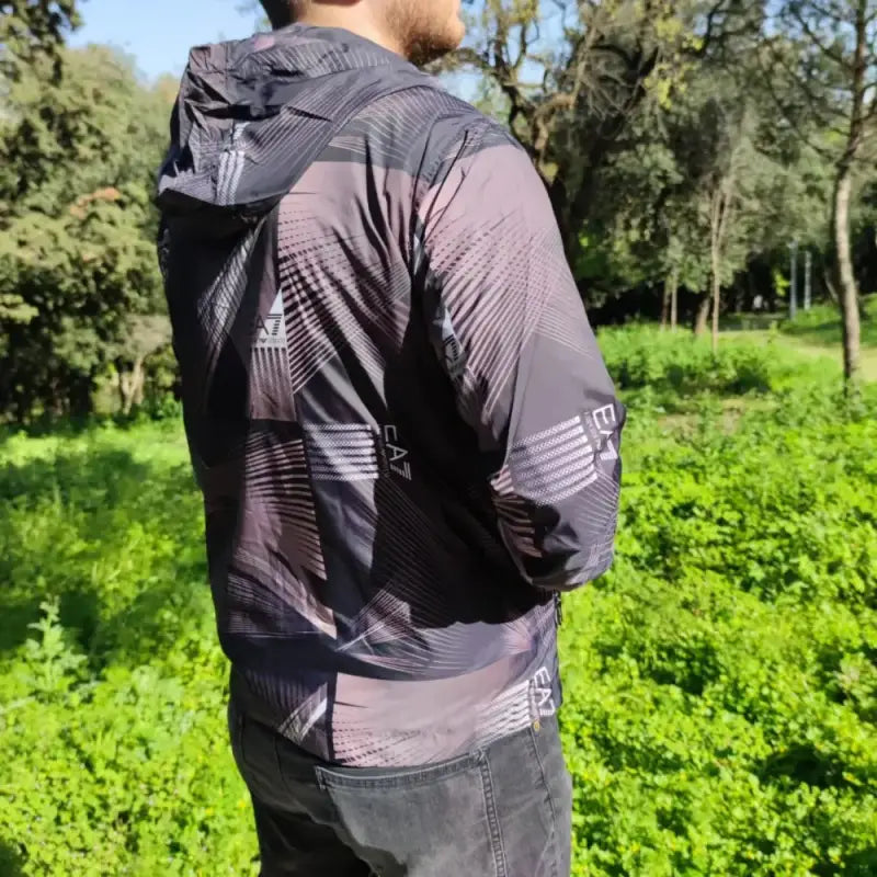 Patterned gray and black athletic windbreaker jacket with a hood.