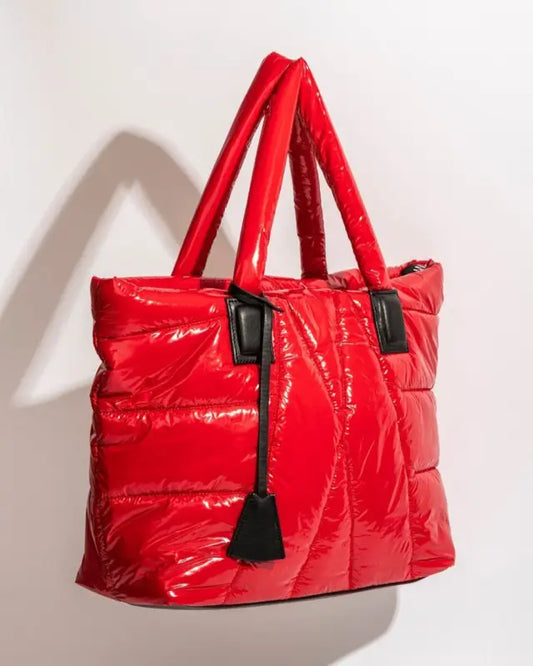 Shiny red quilted tote bag with black handles.