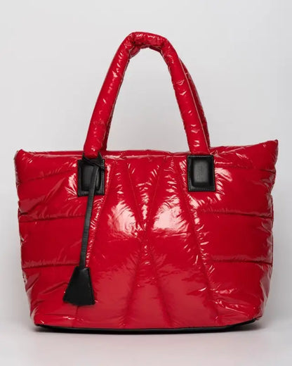 Shiny red quilted puffer tote bag with black handles.