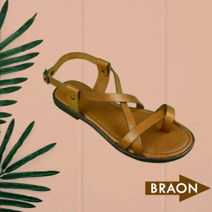 Brown leather strappy sandal with a flat sole.