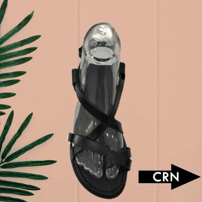 Black strappy sandal with a metallic silver foot form display.