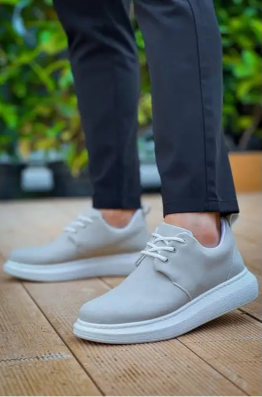 Light gray casual sneakers with white laces and soles.