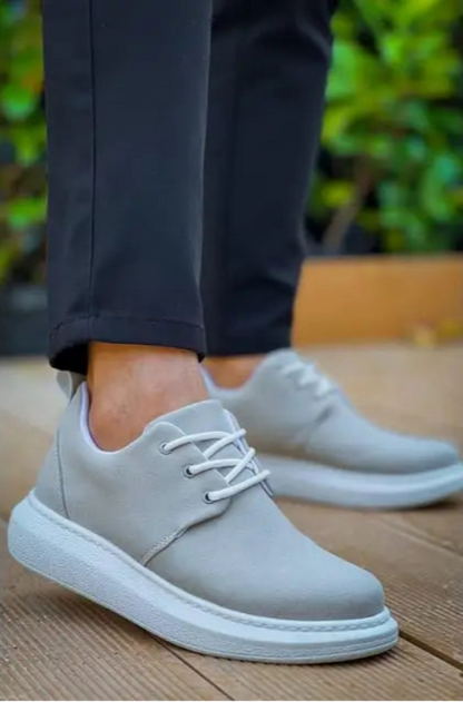 Light gray casual sneaker with white laces and platform sole.