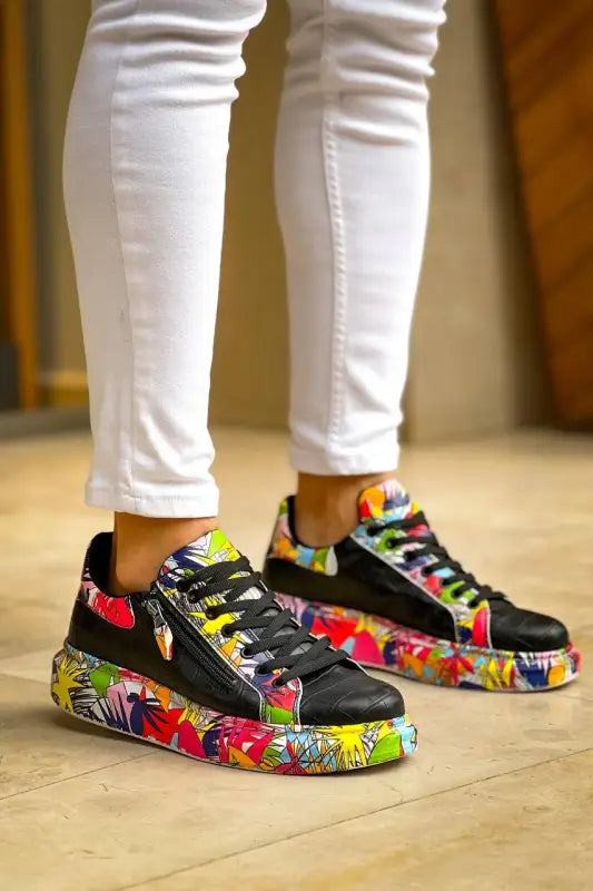 Colorful Nike sneakers with graffiti-style artwork on black base and rainbow laces.