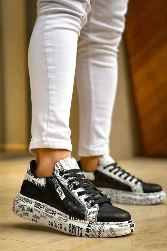 Black and white sneakers with newspaper print design on the sole and upper.