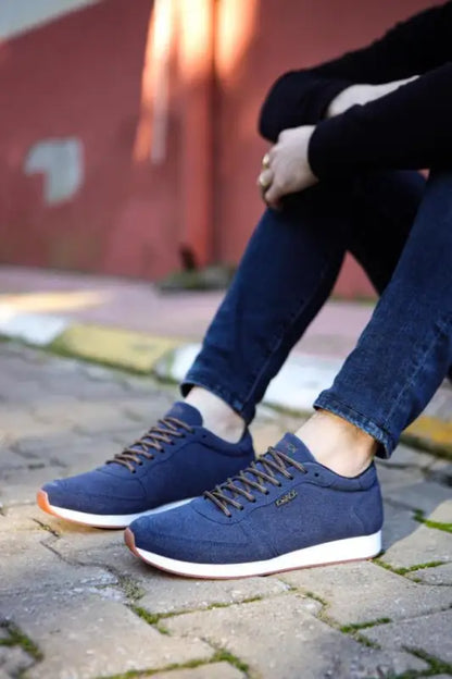 Navy blue canvas sneakers with white soles and gray laces.