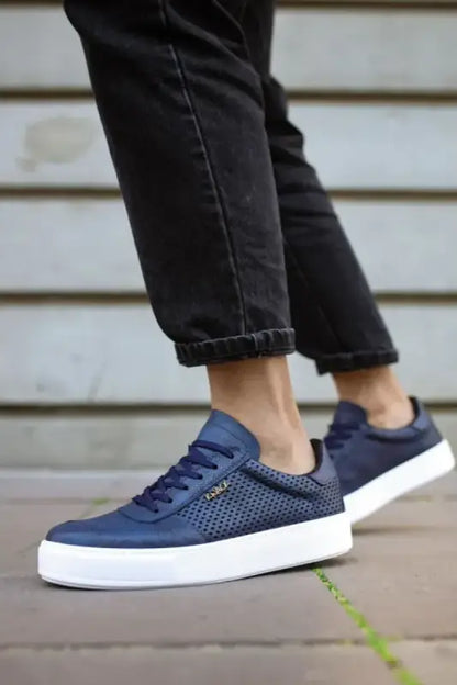 Navy blue sneakers with mesh panels and white soles.