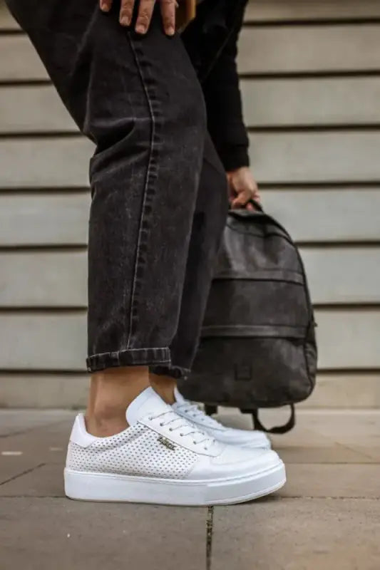 White perforated leather sneakers with a platform sole.