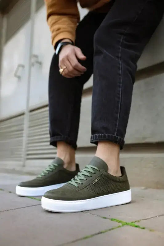 Olive green canvas sneakers with white soles.