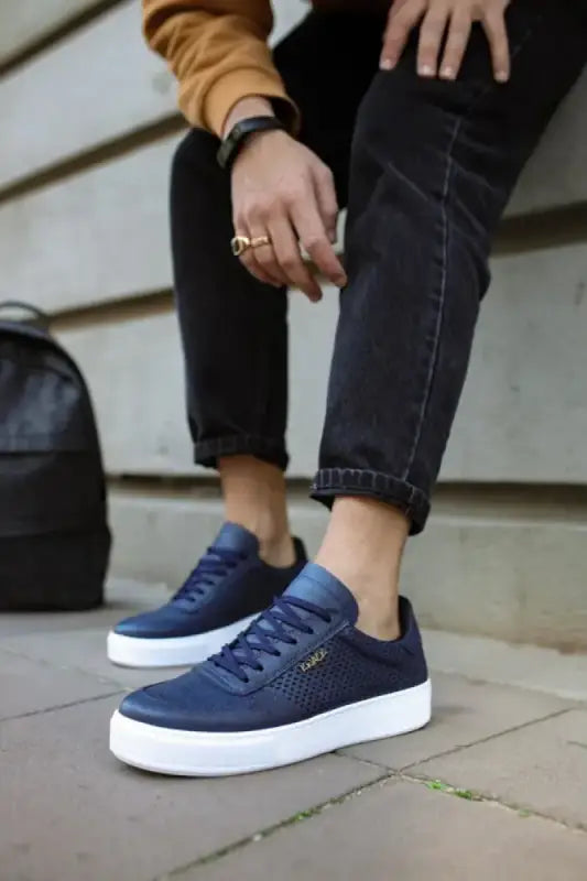 Navy blue canvas sneakers with white soles and laces.