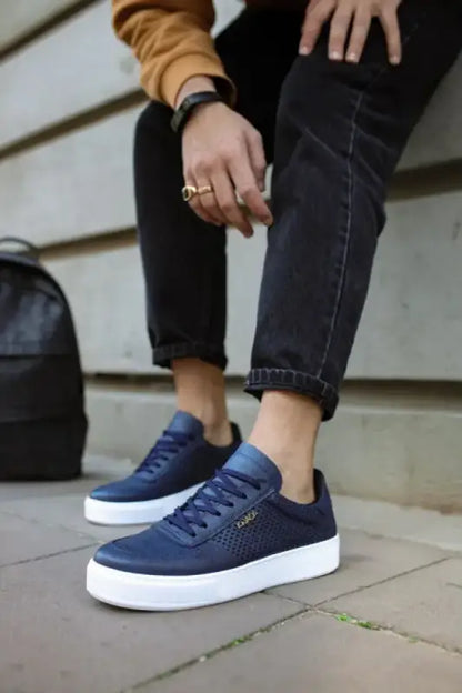 Navy blue canvas sneakers with white soles and laces.