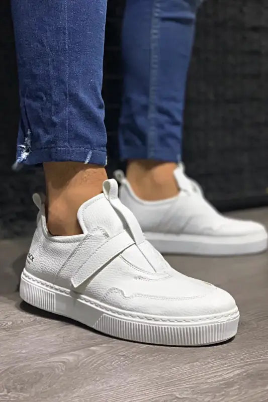 White leather platform sneaker with a velcro strap closure.