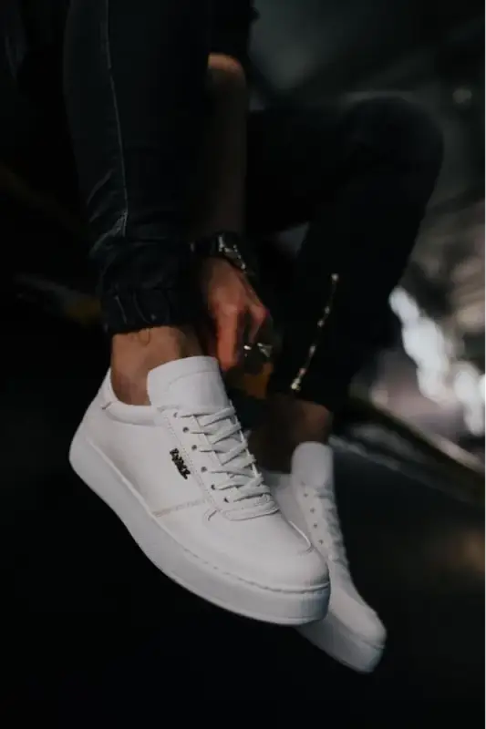 Clean white leather sneaker with laces and a dark logo on the side.