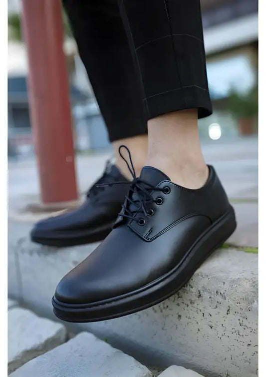 Classic black leather oxford shoe with laces and a chunky sole.