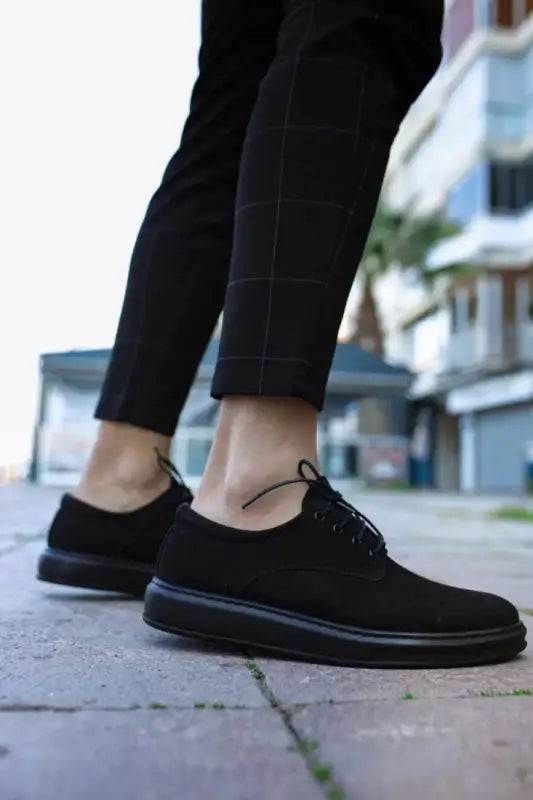 Black canvas oxford shoes with dark soles and laces.