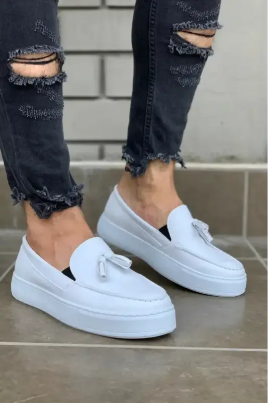 White platform loafers with decorative bow detail.