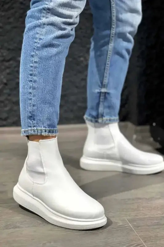 White ankle-height slip-on boots with platform soles.