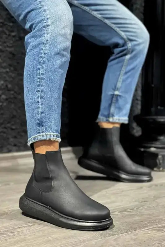 Black leather Chelsea boots with a chunky sole.