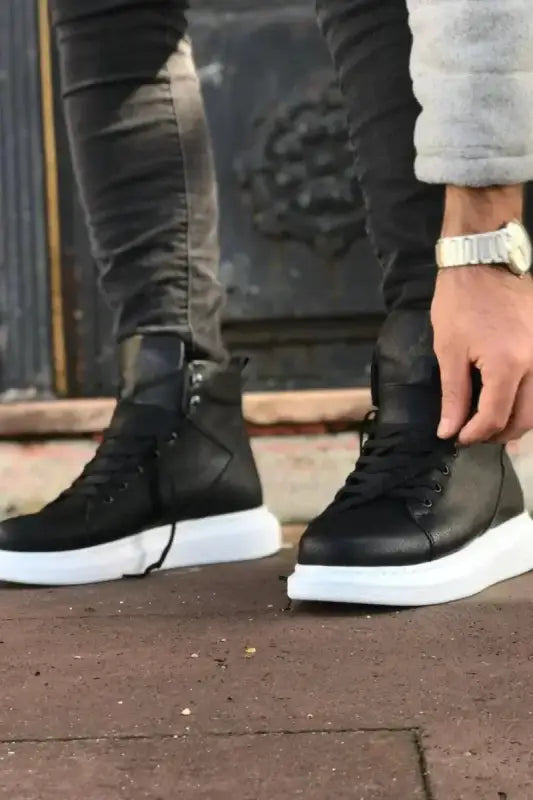 Black high-top sneakers with white soles.