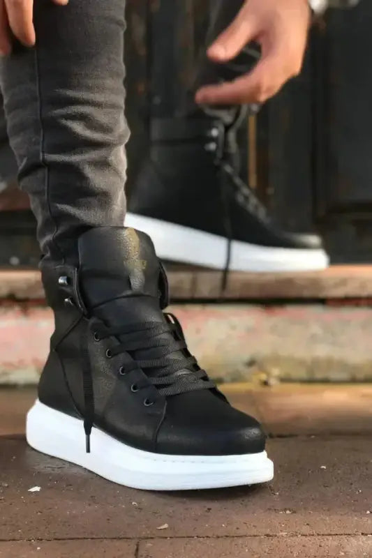 Black high-top sneaker with white sole and laces.