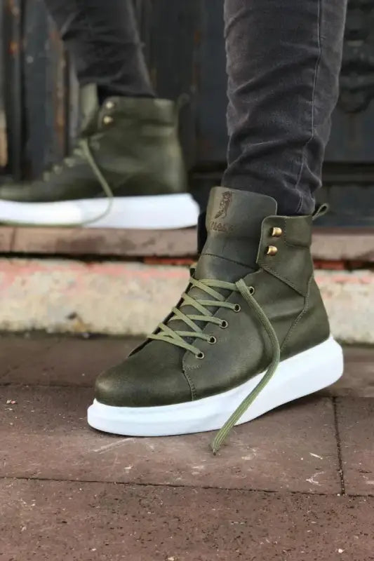 Olive green high-top sneaker with white platform sole and brass hardware.