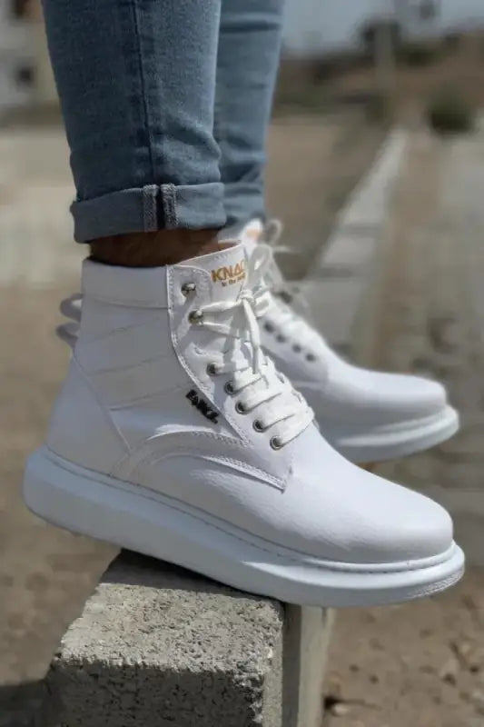 White high-top sneaker with thick soles and laces.