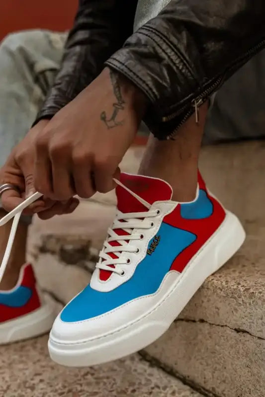 Colorful sneaker featuring white, red and blue panels with white laces.