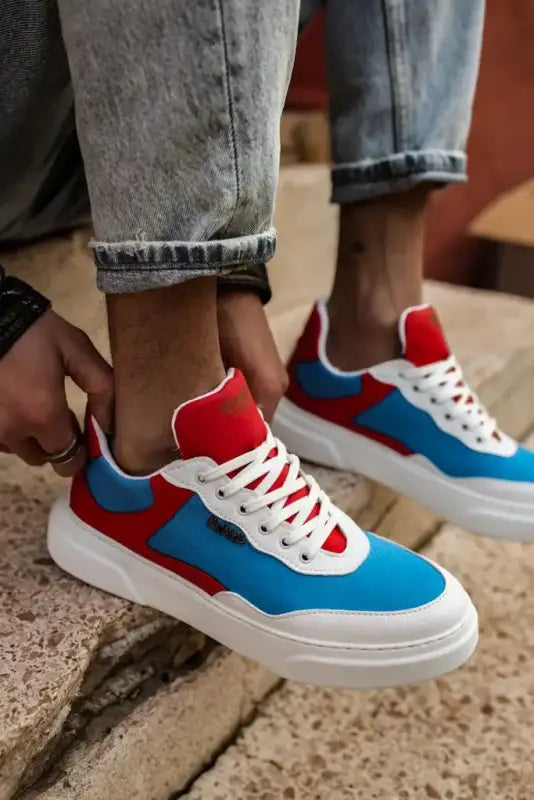 Colorful sneakers featuring blue, red, and white panels with white laces and soles.