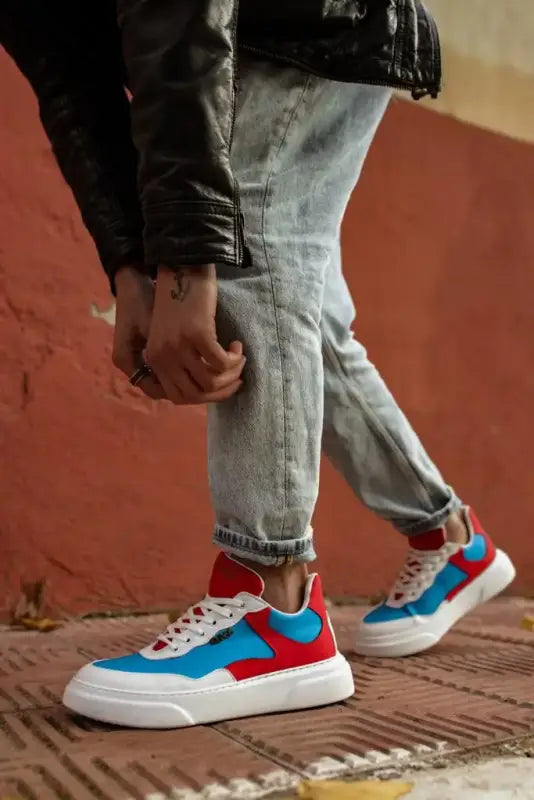 Colorful sneakers featuring blue, red and white panels with a chunky sole design.