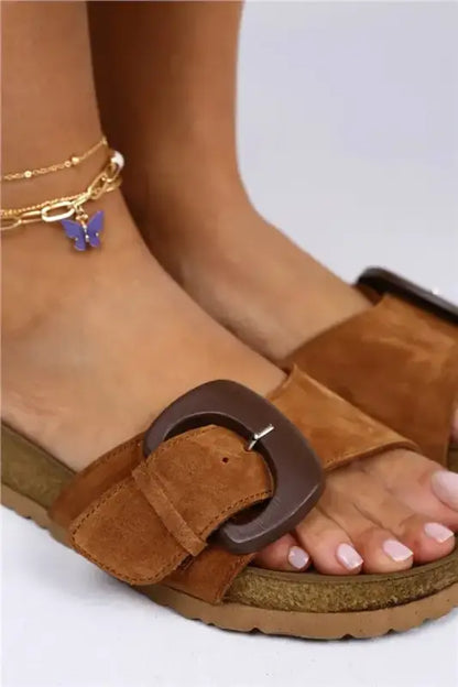 Brown suede sandal with a buckle detail and a cork footbed.