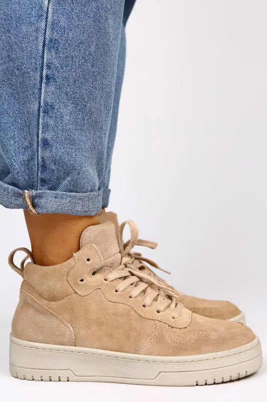 Beige suede high-top sneaker with cream-colored laces and platform sole.