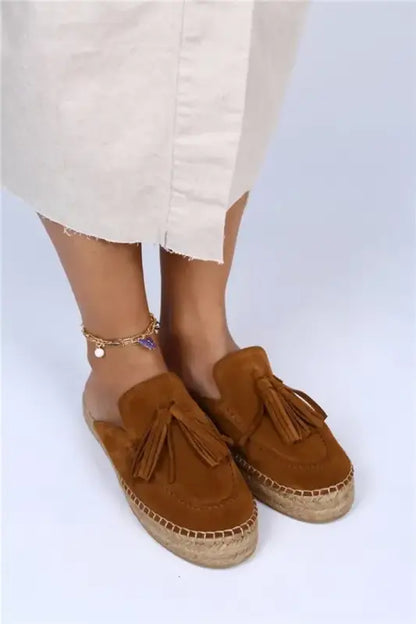 Brown suede espadrilles with tassels and a braided jute sole.