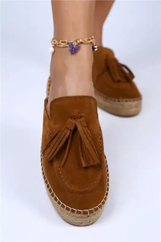 Brown suede tassel loafer with an espadrille sole.