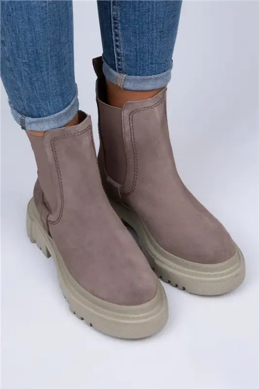 Taupe chelsea boots with chunky platform soles and elastic side panels.