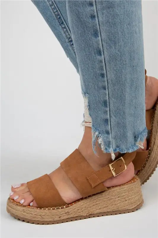 Tan leather platform sandal with buckle straps and an espadrille-style rope sole.