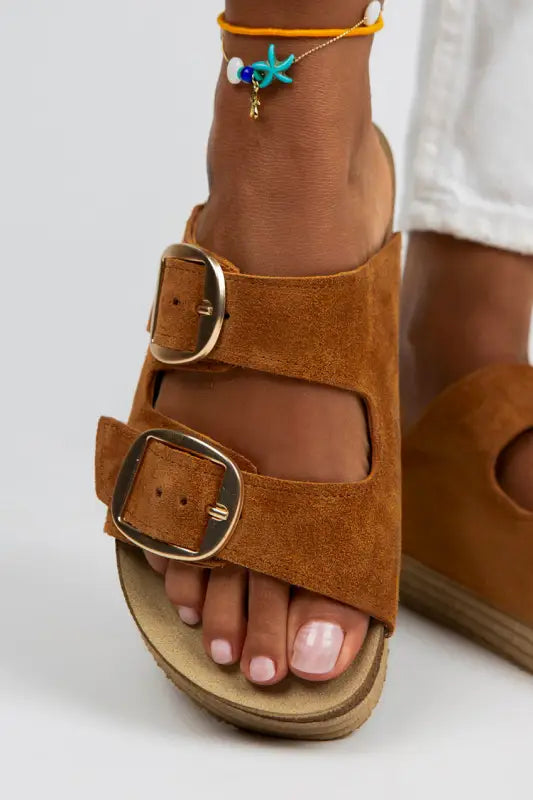 Brown suede double-buckle sandal with a cork footbed.