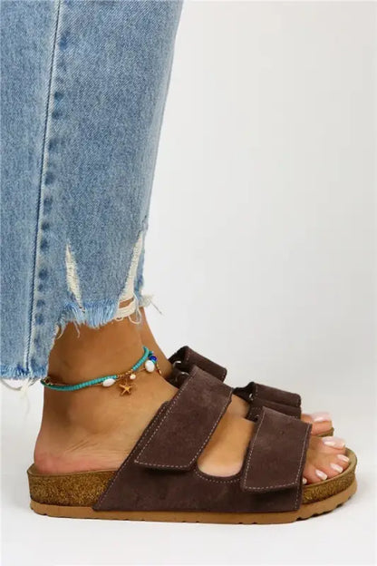 Brown suede double-strap sandal with cork footbed worn with distressed jeans and turquoise anklet.