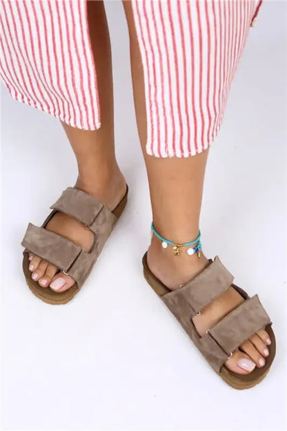 Taupe suede Birkenstock-style sandals with two adjustable straps.