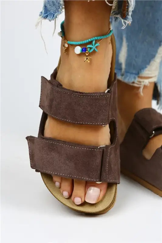 Brown suede double-strap sandal with a cork footbed.