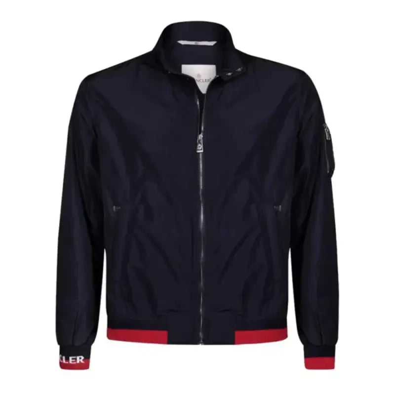 Navy blue bomber jacket with red trim at the cuffs and waistband.