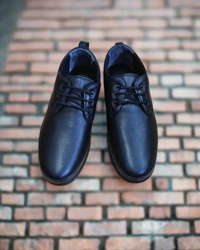 Black leather lace-up dress shoes with a simple, classic design.