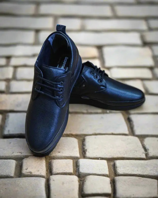 Black leather casual lace-up shoes with a simple design.